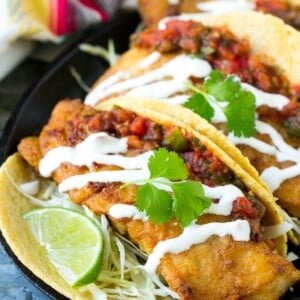 This recipe for Baja fish tacos is crispy fish fillets with cabbage, salsa and creamy sauce, all wrapped in warm corn tortillas. Just like you'd get in a restaurant, except better!