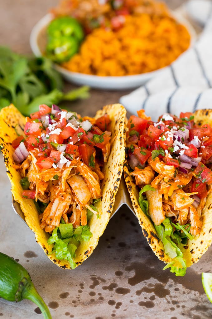 Chicken tinga tacos with lettuce and pico de gallo.